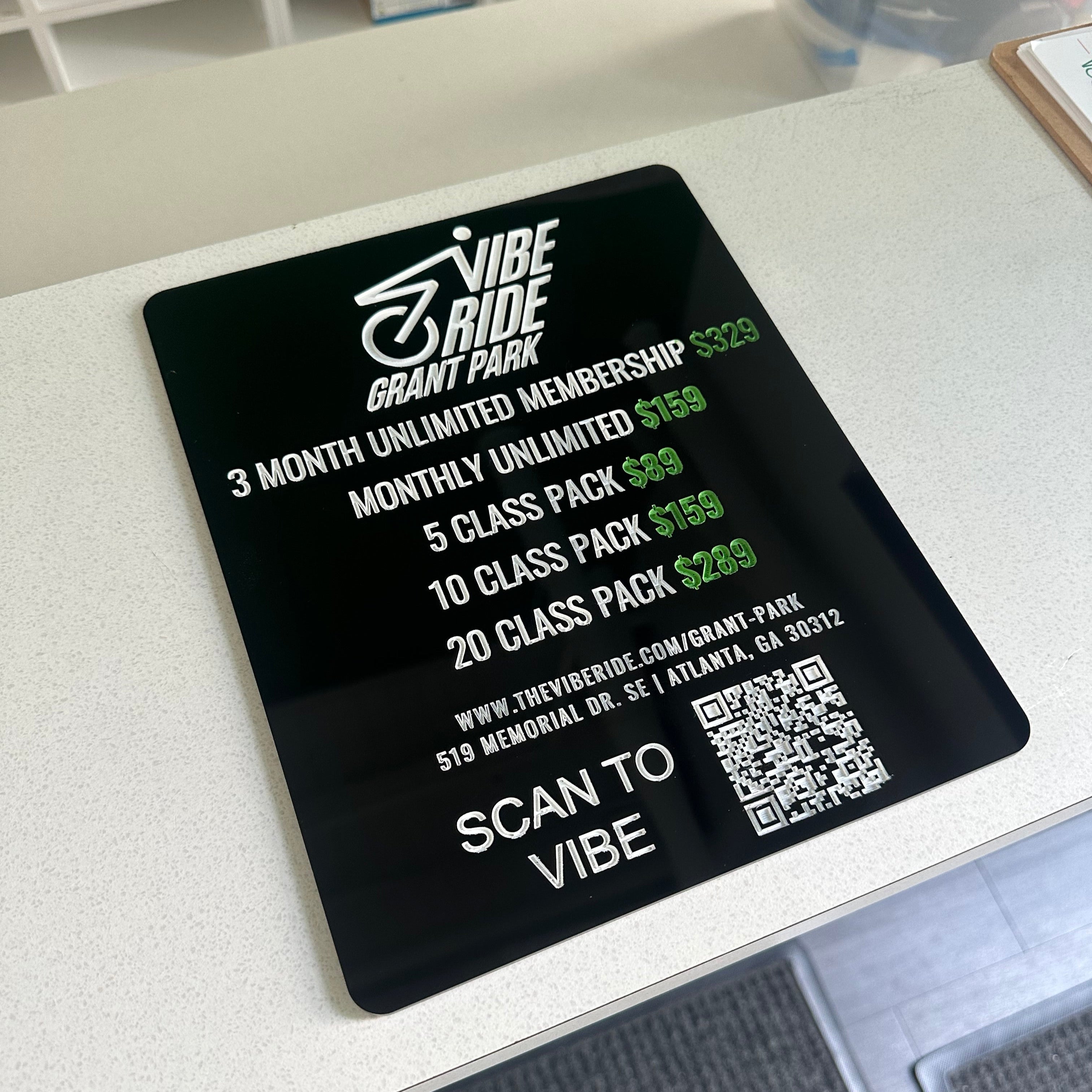 black acrylic price sheet with white text, price sign for business, small business signage, qr code sign, acrylic signage, sign vendor in atlanta, atl sign vendor, acrylic, vibe ride grant park atlanta, atl cycling studio sign, party signage, professional sign company, professional sign vendor in atlanta, southeast region sign company, lioness engraving, engraved signage, engraving company in atlanta