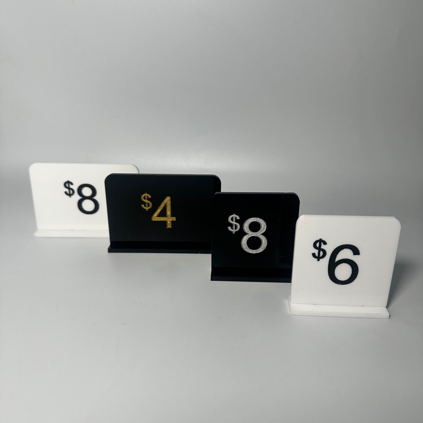 white retail display labels, acrylic retail labels, mini price signs for boutiques, boutique price labels, custom pricing signs, lioness engraving signs, lioness engraving, store set up essentials, black retail display labels, reusable sale signage, opening up a store, bakery retail sign, 