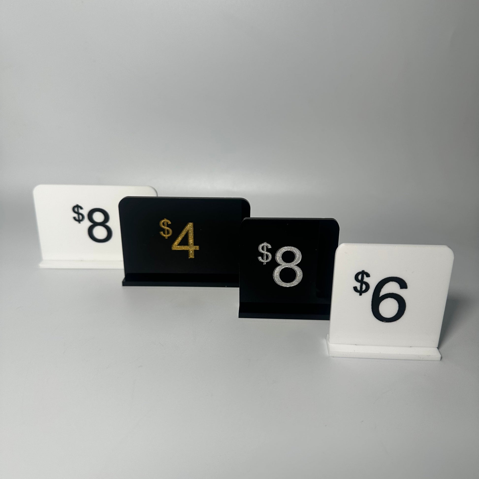 white retail display labels, acrylic retail labels, mini price signs for boutiques, boutique price labels, custom pricing signs, lioness engraving signs, lioness engraving, store set up essentials, black retail display labels, reusable sale signage, opening up a store, bakery retail sign, 