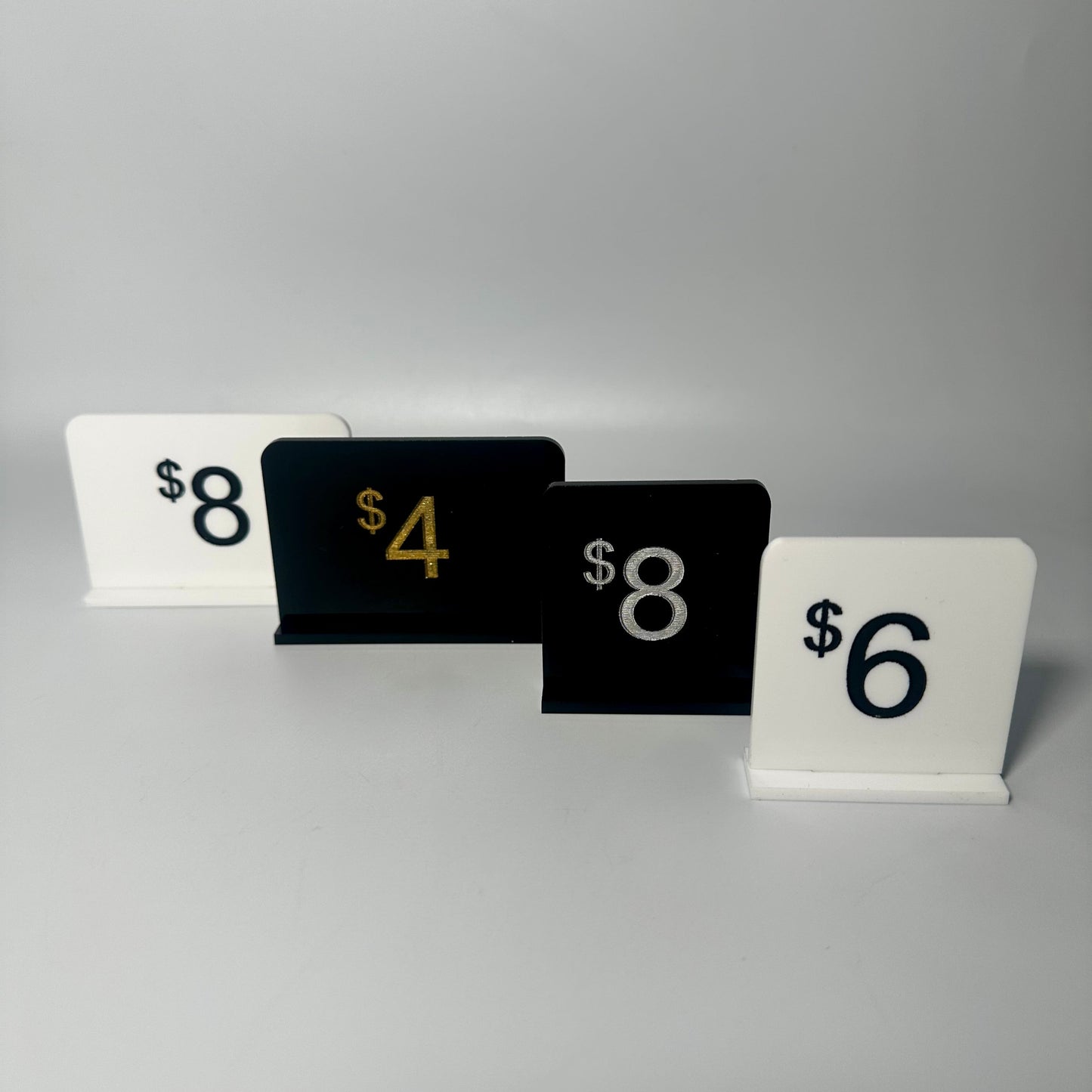 white retail display labels, acrylic retail labels, mini price signs for boutiques, boutique price labels, custom pricing signs, lioness engraving signs, lioness engraving, store set up essentials, black retail display labels, reusable sale signage, opening up a store, bakery retail sign, 