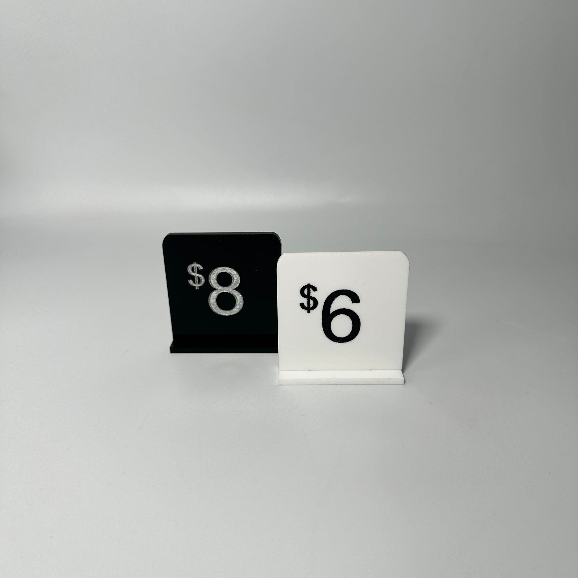 white retail display labels, acrylic retail labels, mini price signs for boutiques, boutique price labels, custom pricing signs, lioness engraving signs, lioness engraving, store set up essentials, black retail display labels, reusable sale signage, opening up a store, bakery retail sign, 