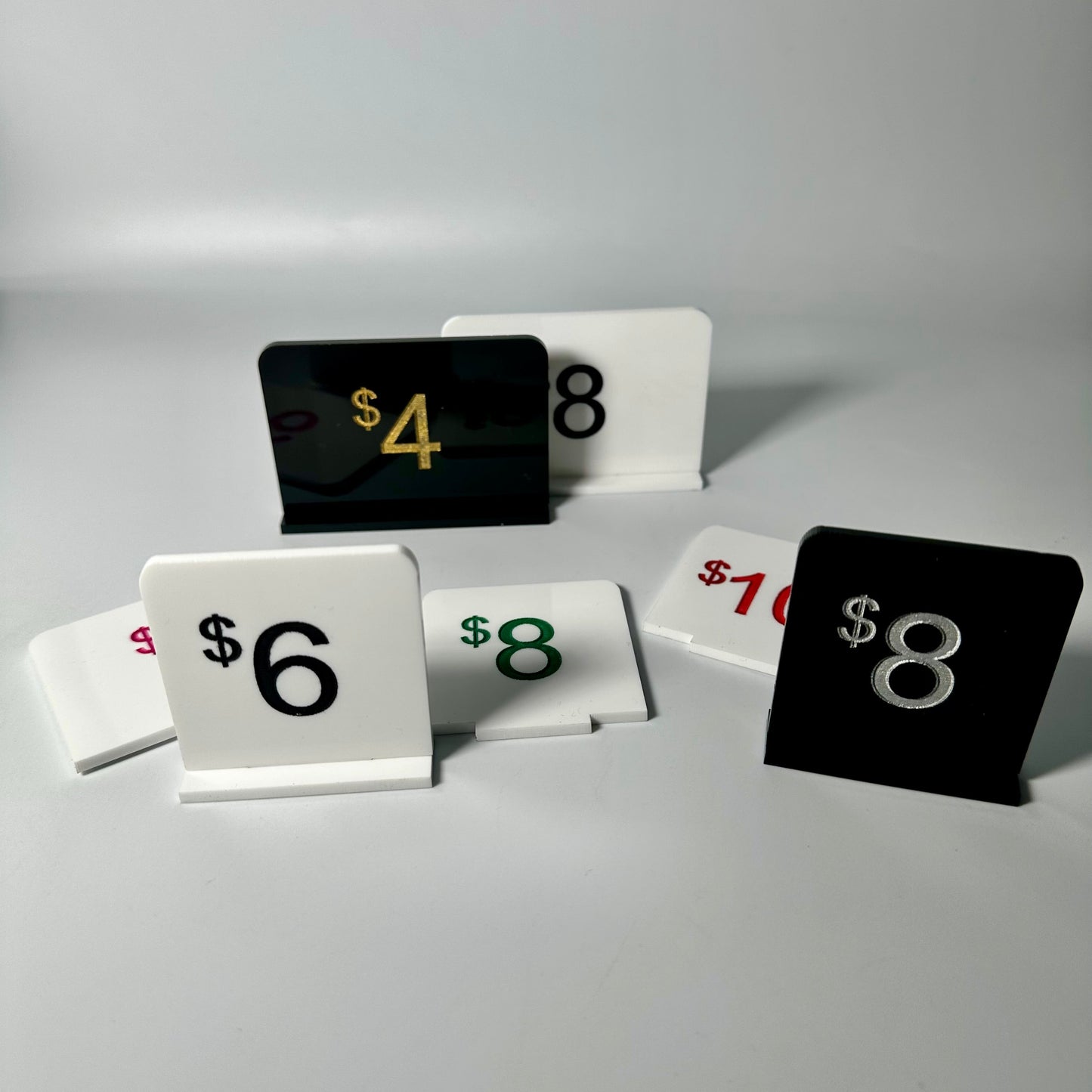 white retail display labels, acrylic retail labels, mini price signs for boutiques, boutique price labels, custom pricing signs, lioness engraving signs, lioness engraving, store set up essentials, black retail display labels, reusable sale signage, opening up a store, bakery retail sign, 